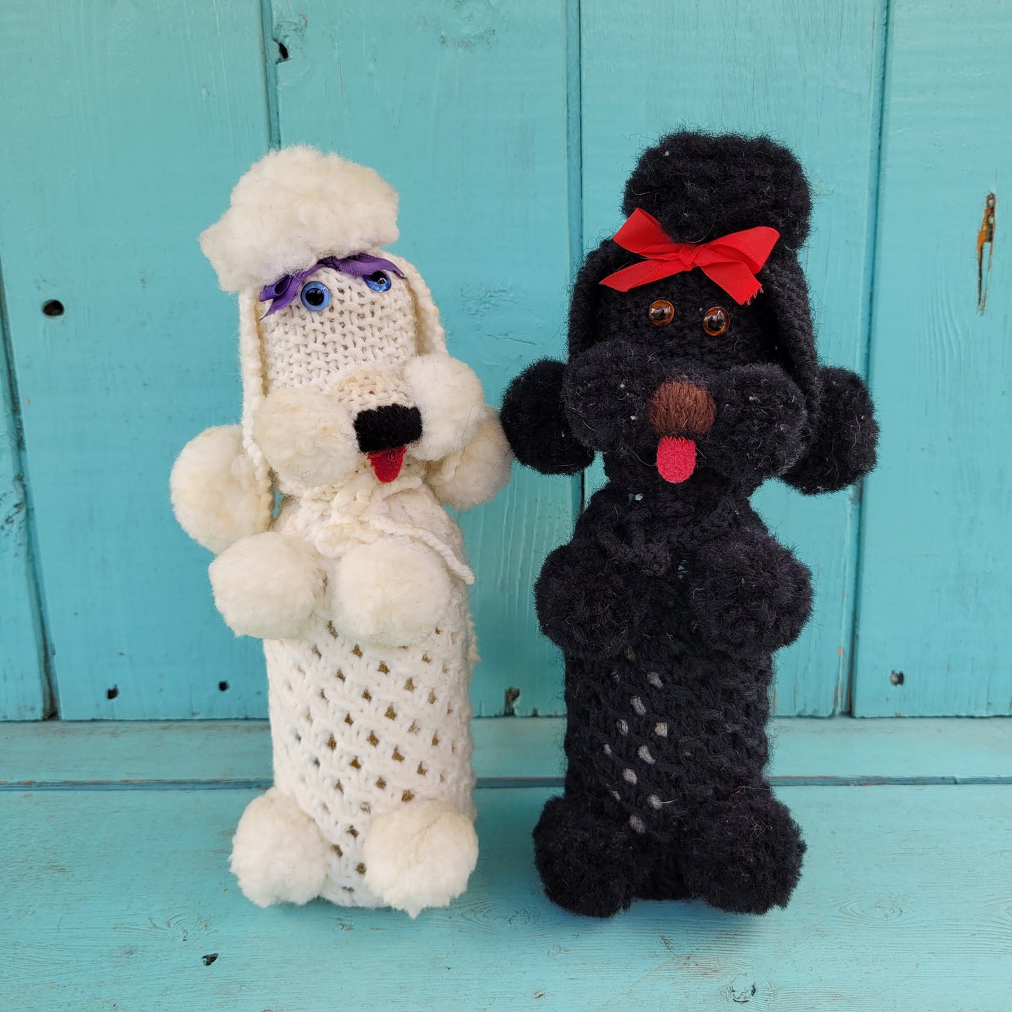Two 1960s/70s crocheted poodle eau de toilette bottle covers with contents