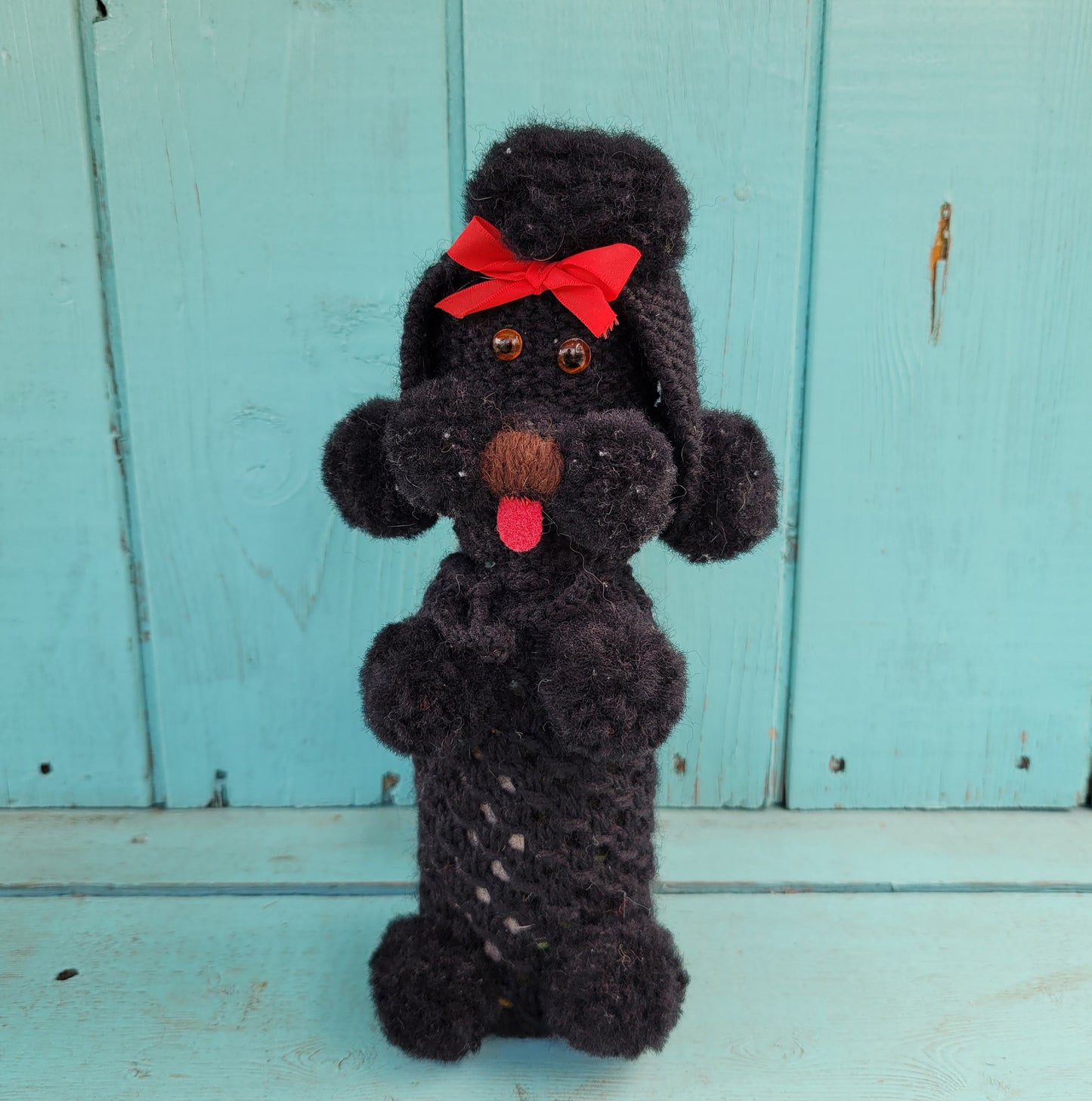 Two 1960s/70s crocheted poodle eau de toilette bottle covers with contents