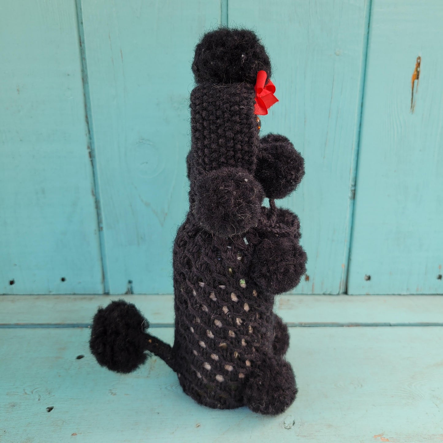 Two 1960s/70s crocheted poodle eau de toilette bottle covers with contents