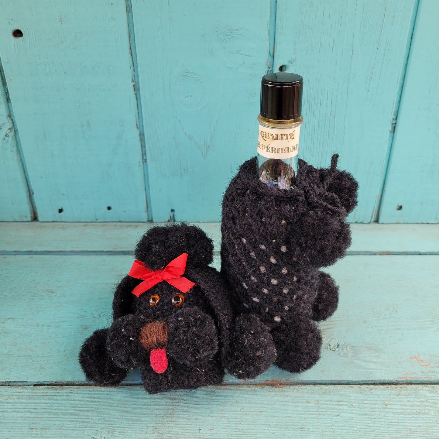 Two 1960s/70s crocheted poodle eau de toilette bottle covers with contents