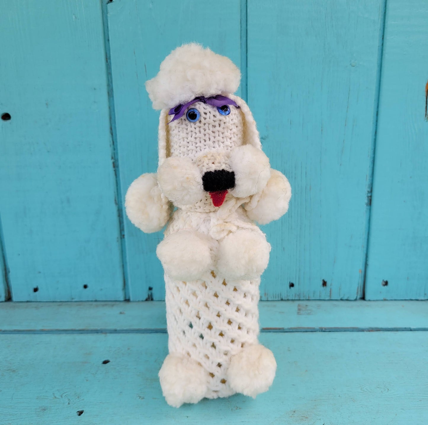 Two 1960s/70s crocheted poodle eau de toilette bottle covers with contents