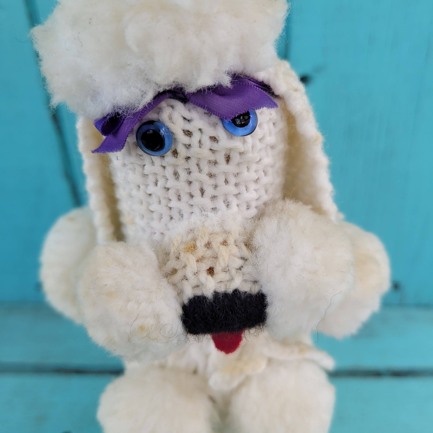 Two 1960s/70s crocheted poodle eau de toilette bottle covers with contents