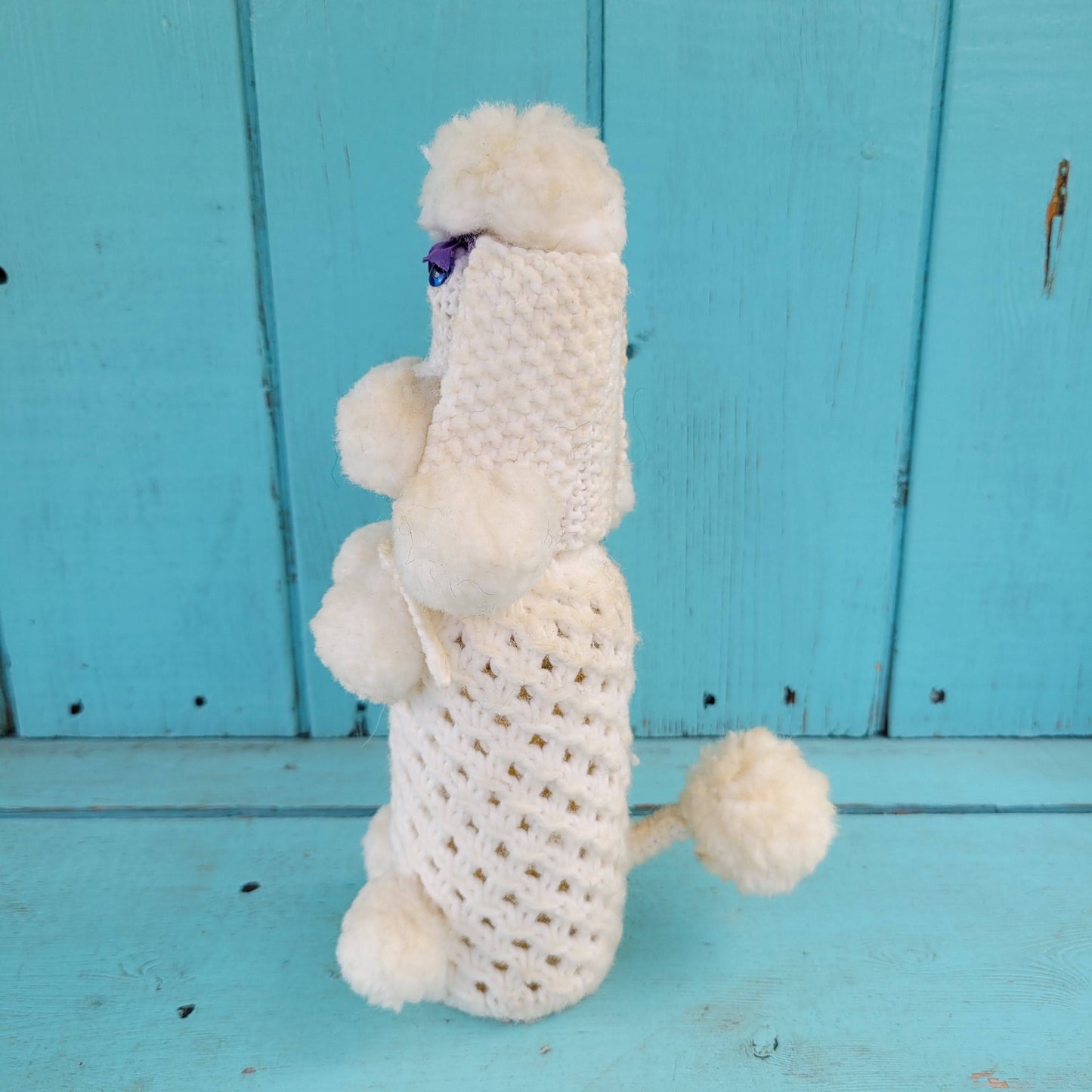 Two 1960s/70s crocheted poodle eau de toilette bottle covers with contents