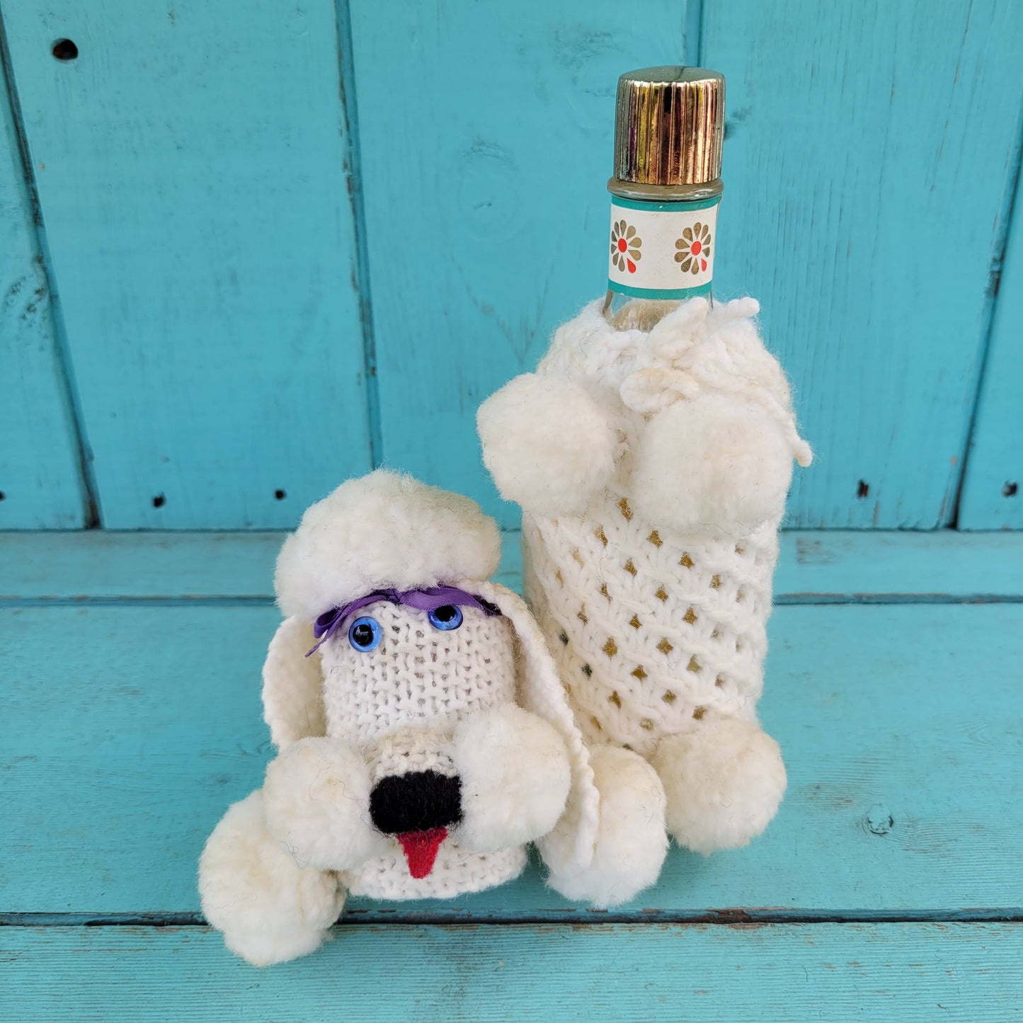 Two 1960s/70s crocheted poodle eau de toilette bottle covers with contents