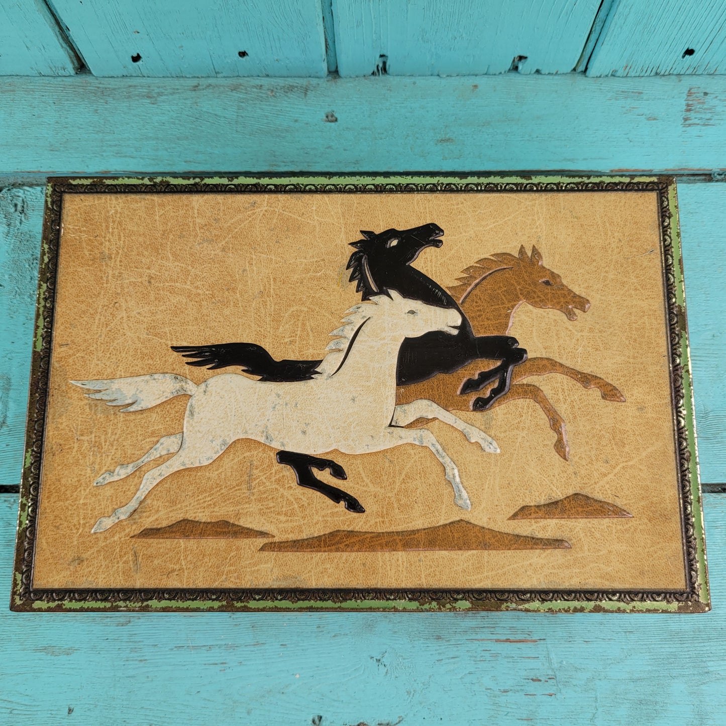 Vintage Chymos, Finland, rectangular candy tin with embossed galloping horses design