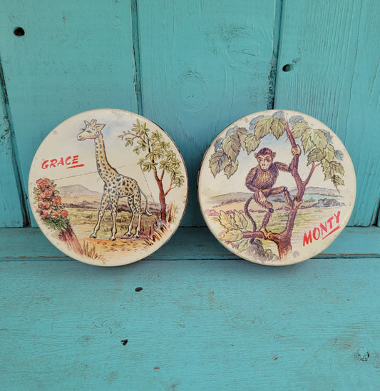 Two 1950s Huntley & Palmer's round mini biscuit tins, Grace the giraffe, and Monty the monkey