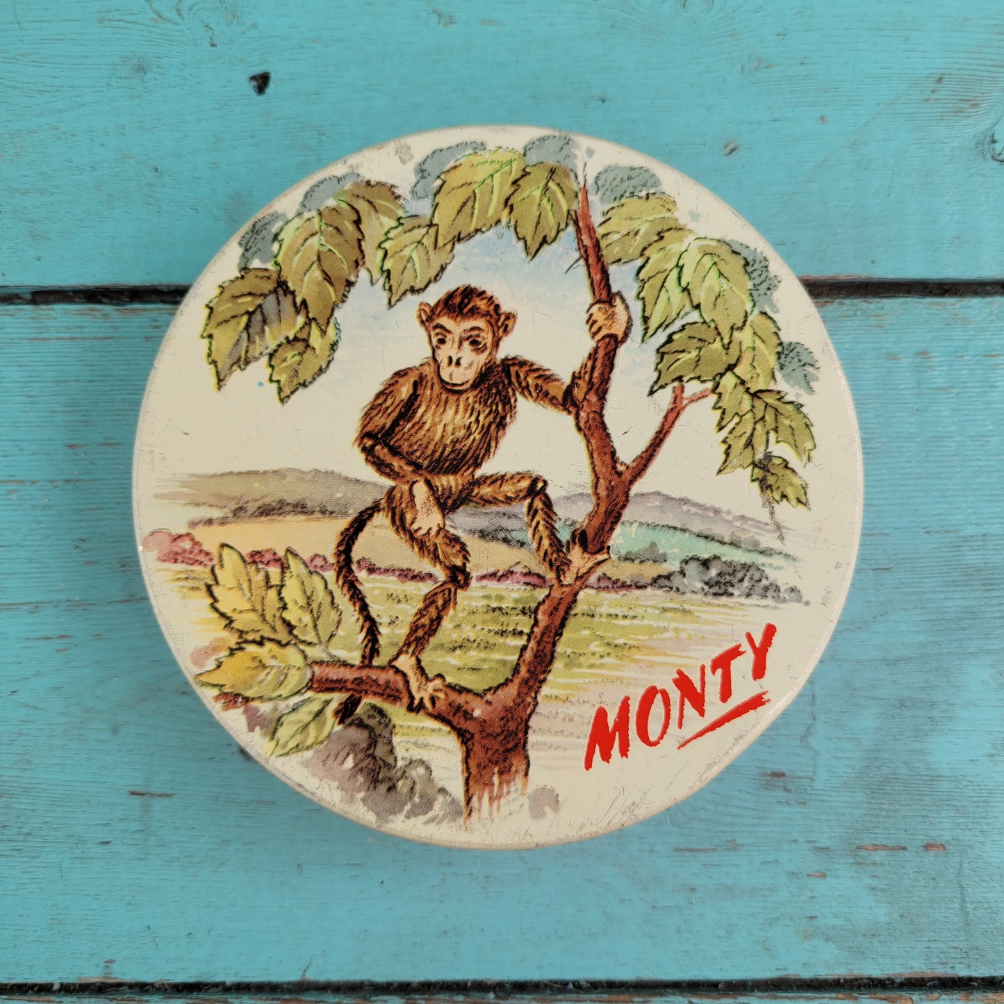 Two 1950s Huntley & Palmer's round mini biscuit tins, Grace the giraffe, and Monty the monkey