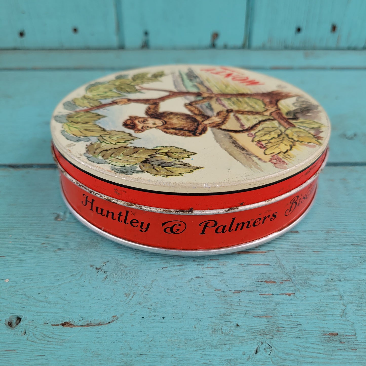 Two 1950s Huntley & Palmer's round mini biscuit tins, Grace the giraffe, and Monty the monkey