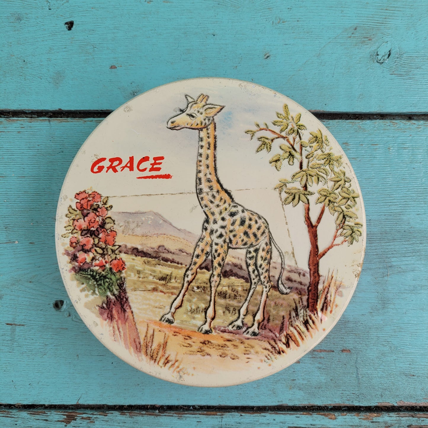 Two 1950s Huntley & Palmer's round mini biscuit tins, Grace the giraffe, and Monty the monkey