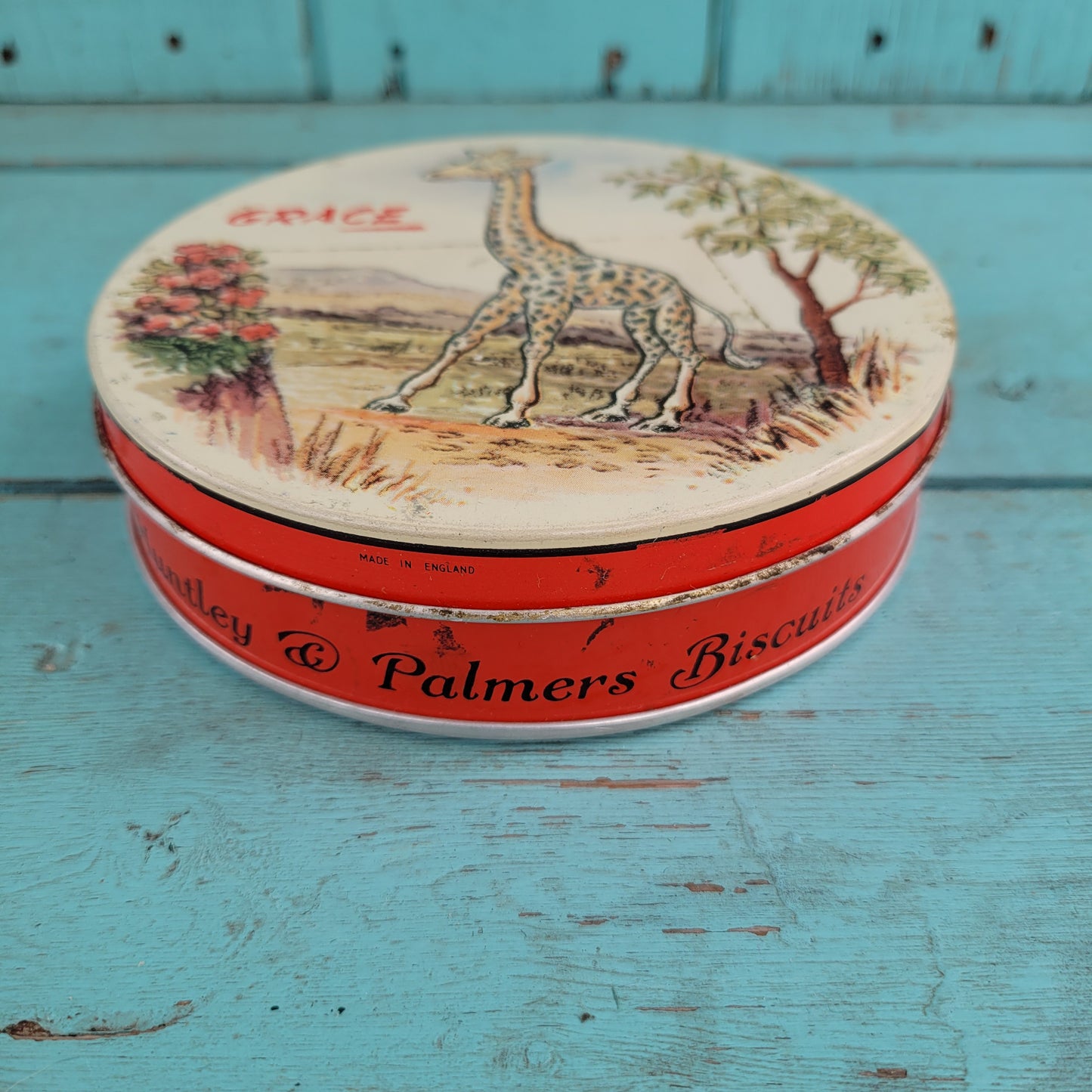 Two 1950s Huntley & Palmer's round mini biscuit tins, Grace the giraffe, and Monty the monkey
