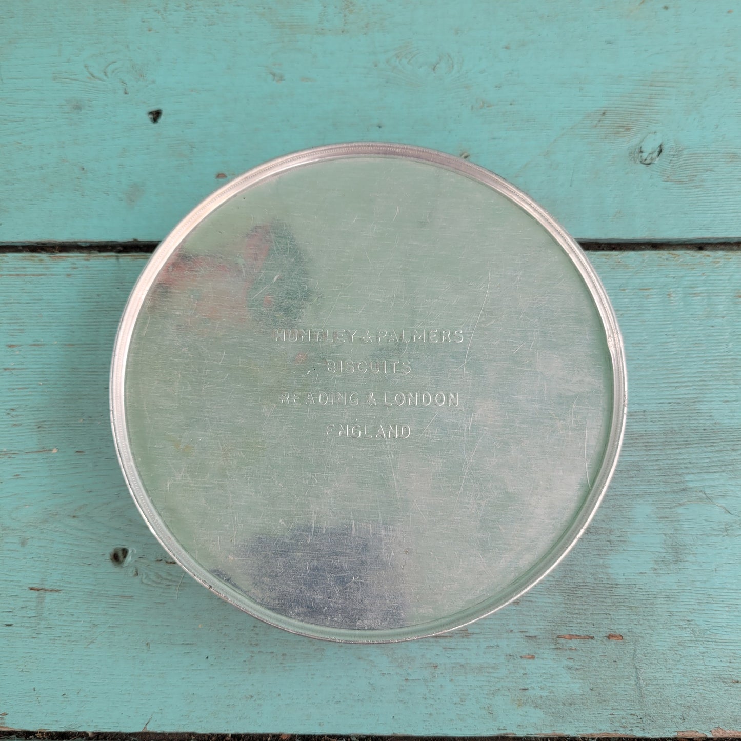 Two 1950s Huntley & Palmer's round mini biscuit tins, Grace the giraffe, and Monty the monkey