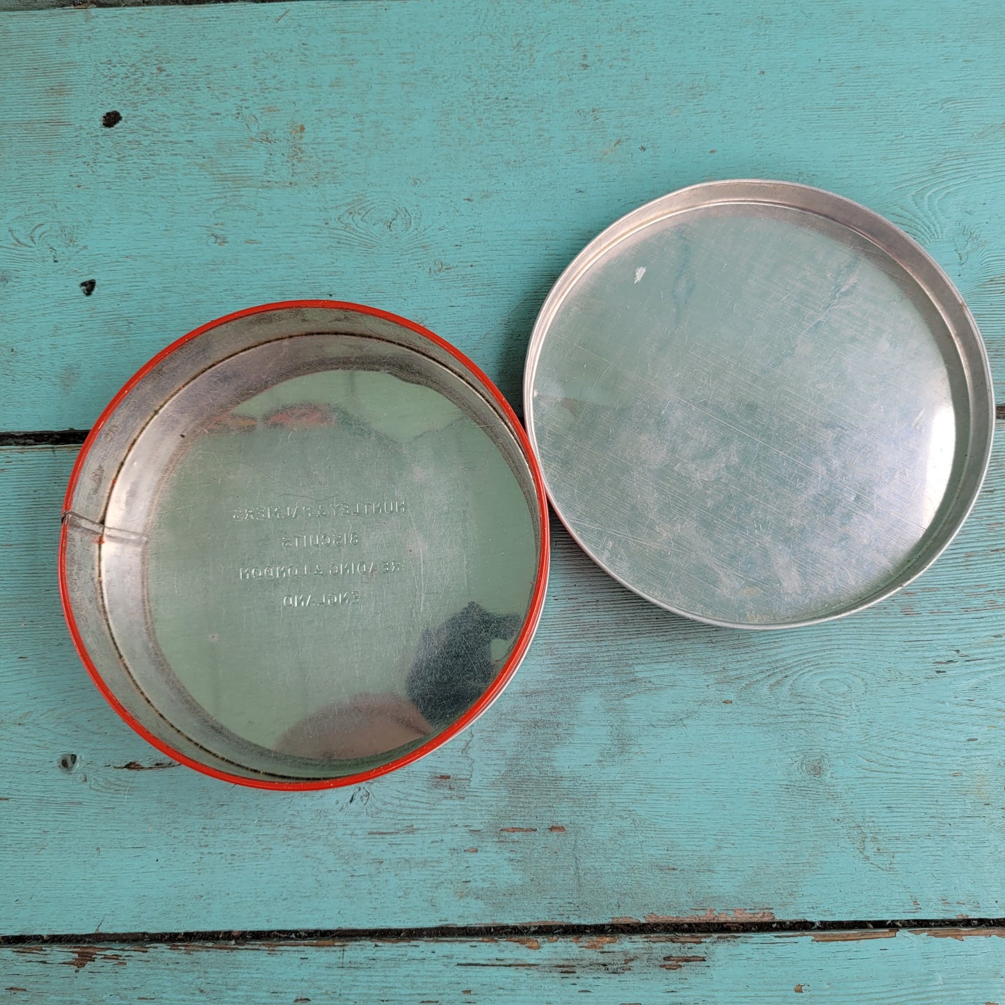 Two 1950s Huntley & Palmer's round mini biscuit tins, Grace the giraffe, and Monty the monkey