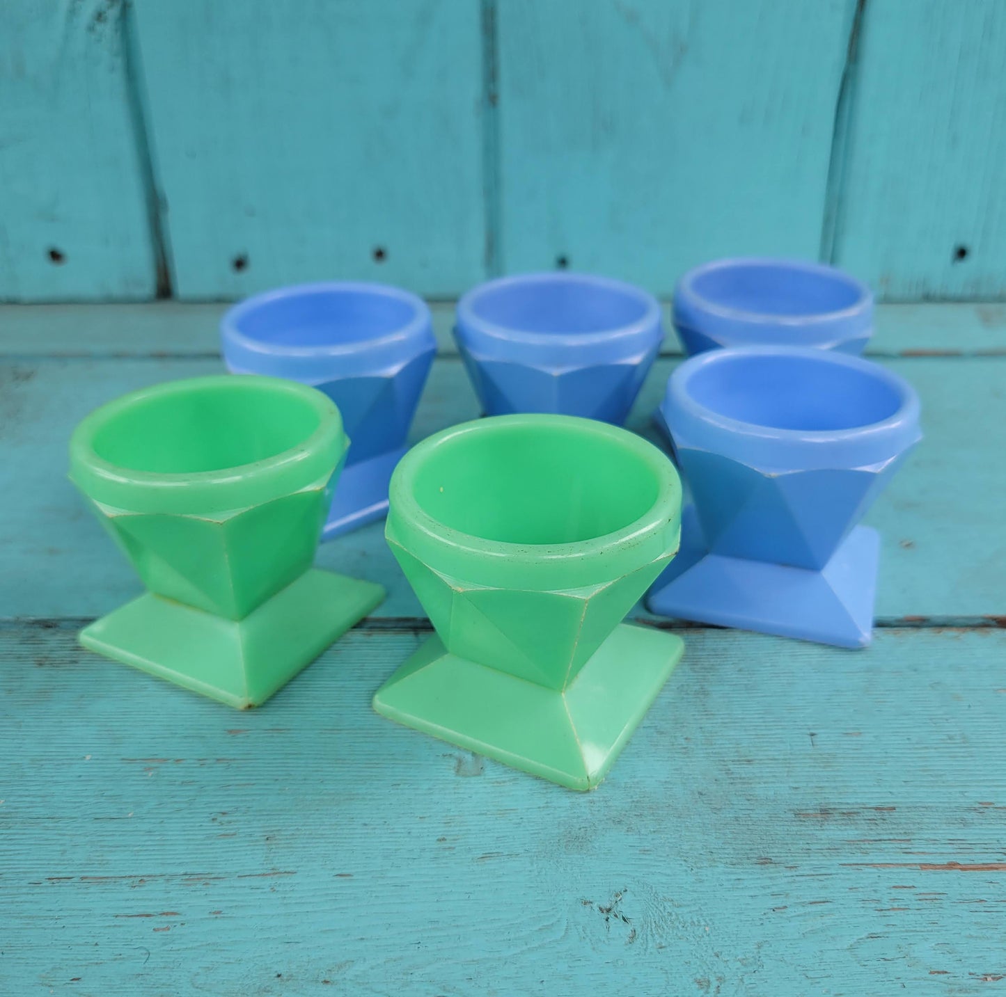 Six 1950s Tudor Rose green, & blue plastic egg cups