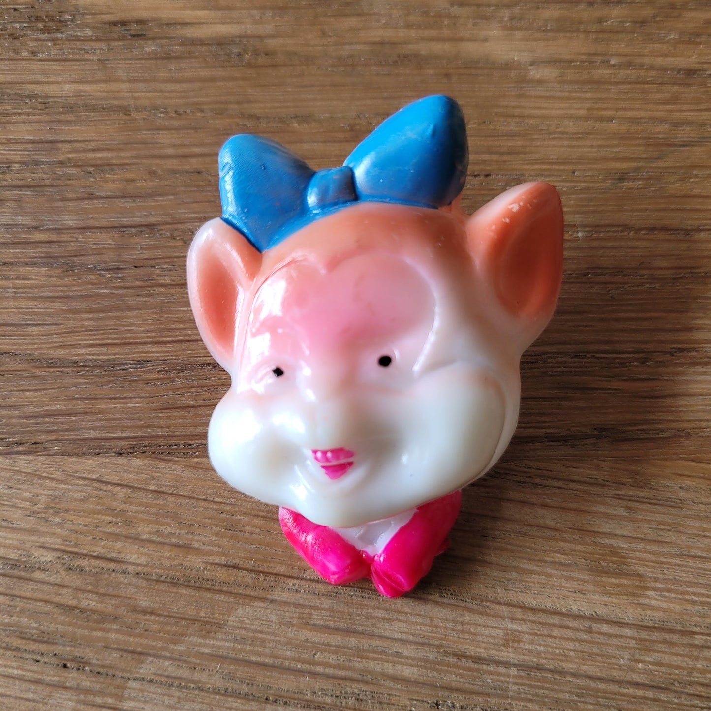 1960s Japanese novelty plastic pig brooch with blue bow