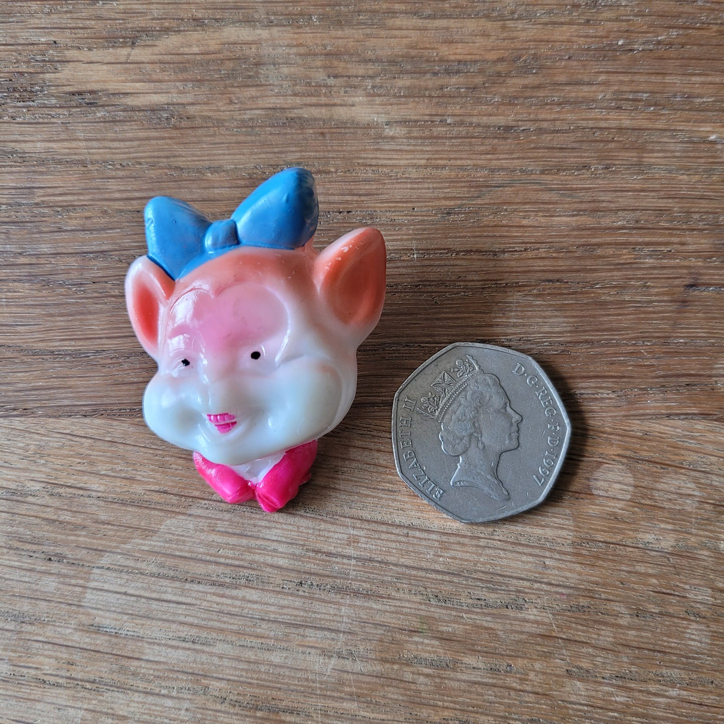 1960s Japanese novelty plastic pig brooch with blue bow