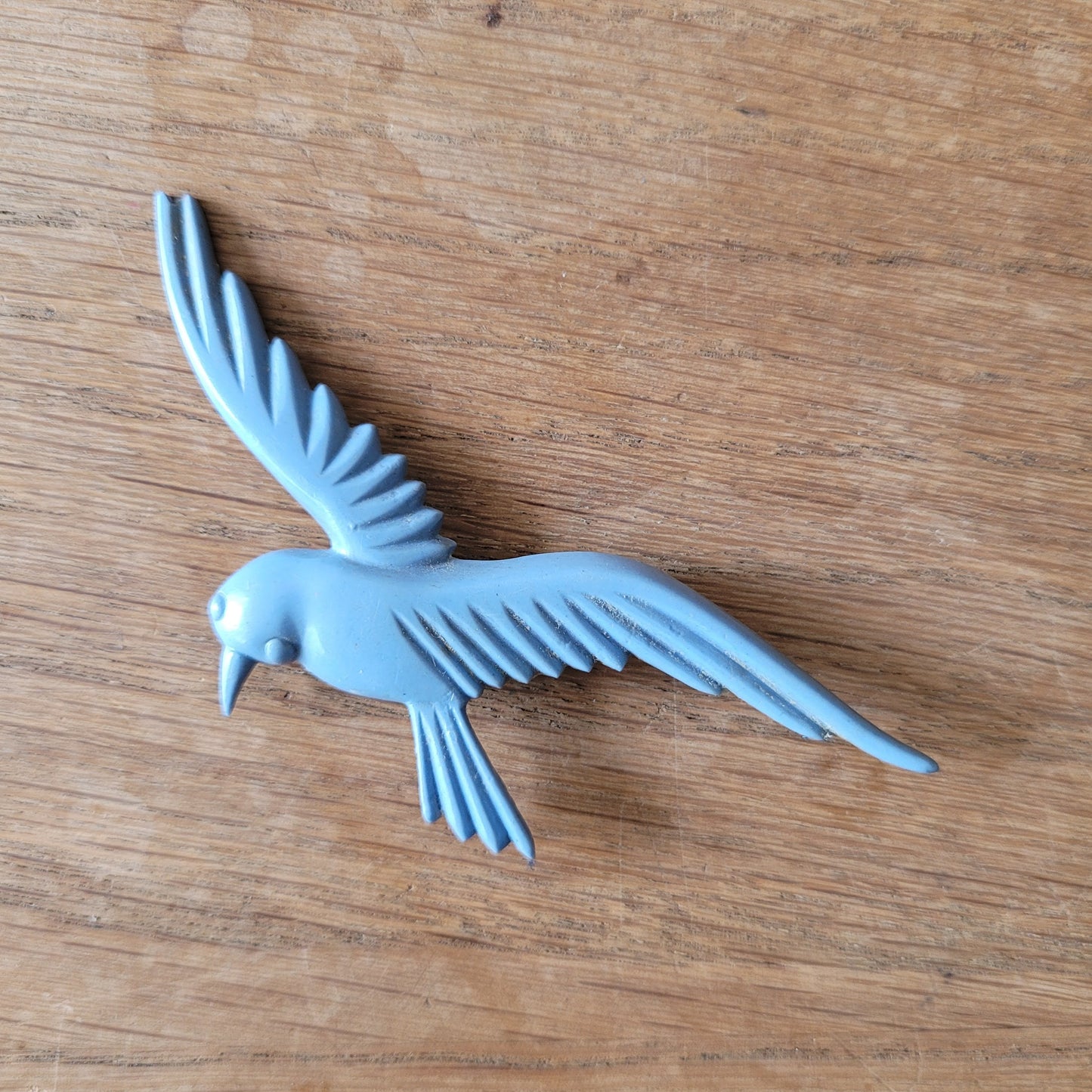 circa. 1930s pale blue celluloid flying bird brooch