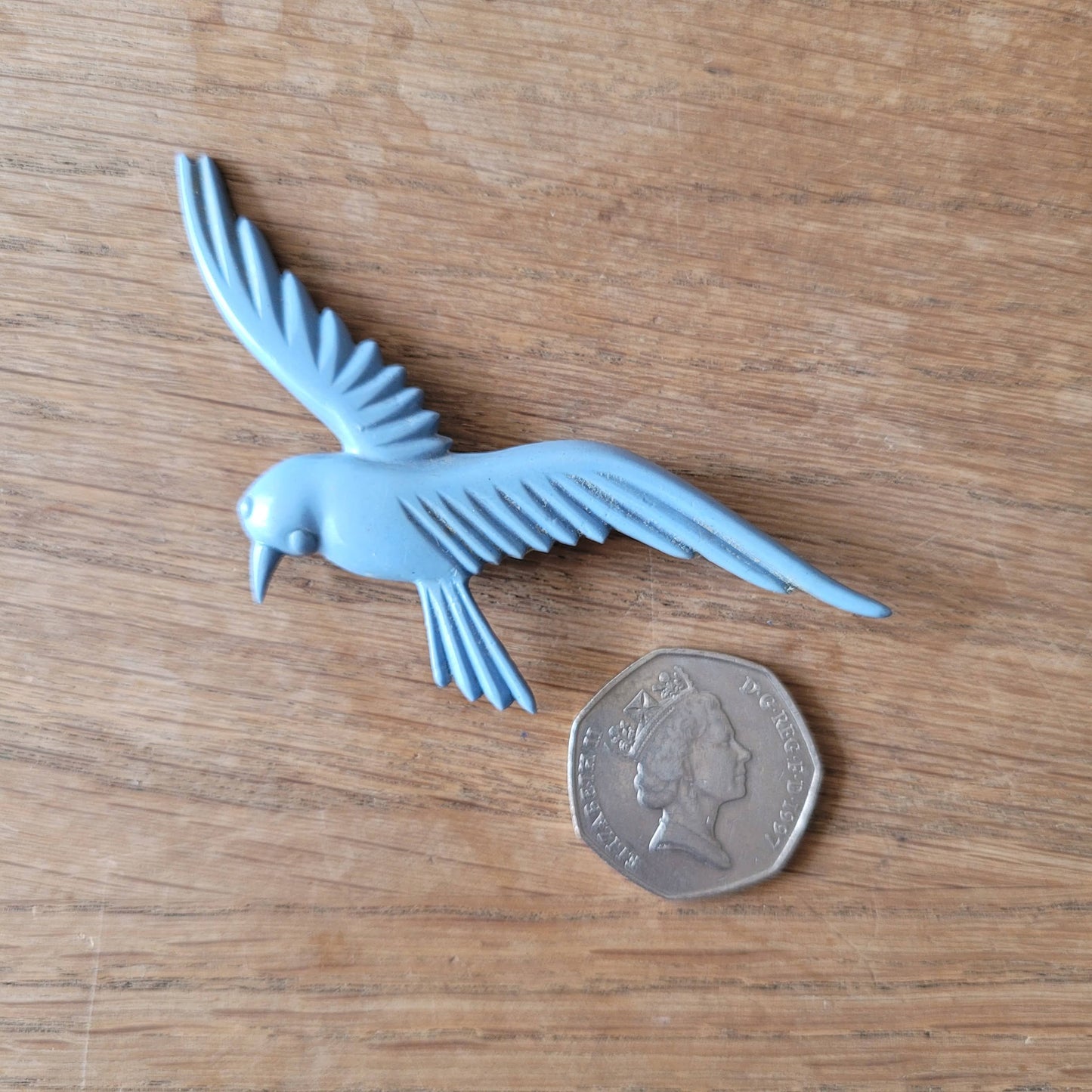 circa. 1930s pale blue celluloid flying bird brooch