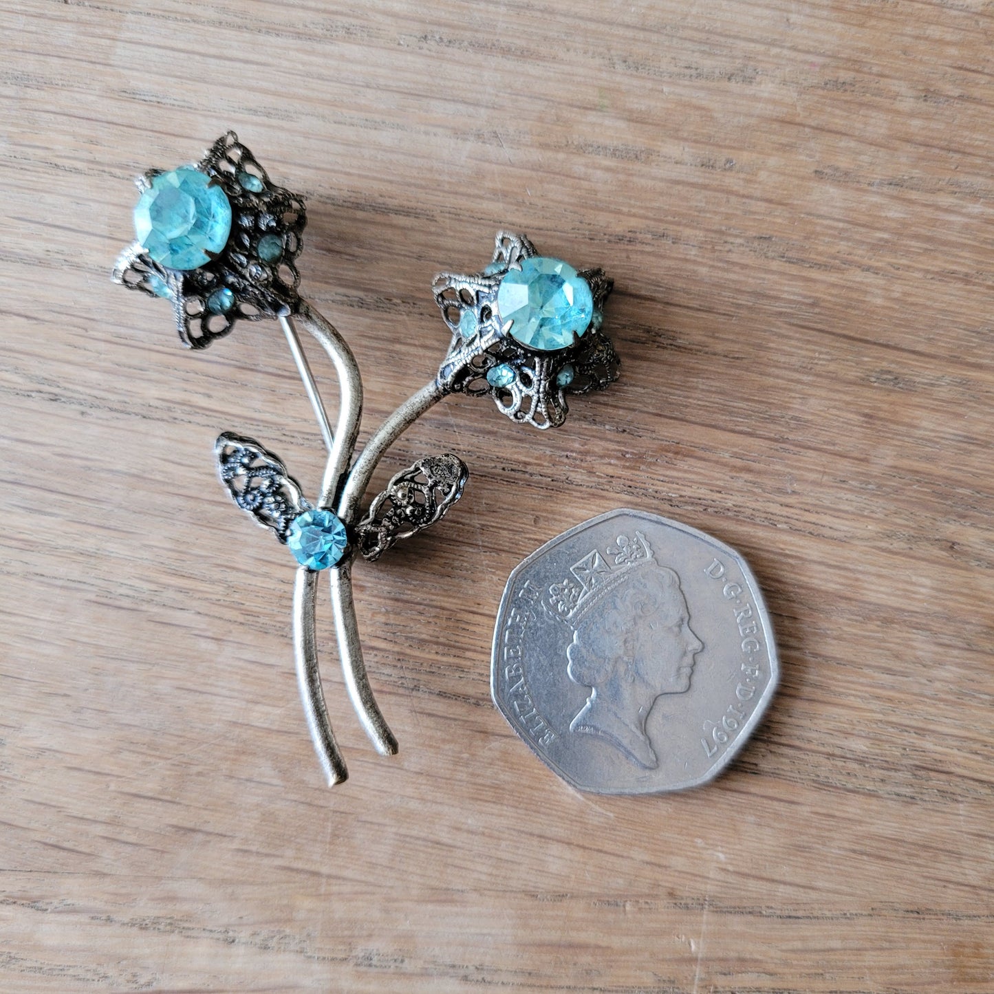 1960s turquoise rhinestone floral spray brooch with filigree detail