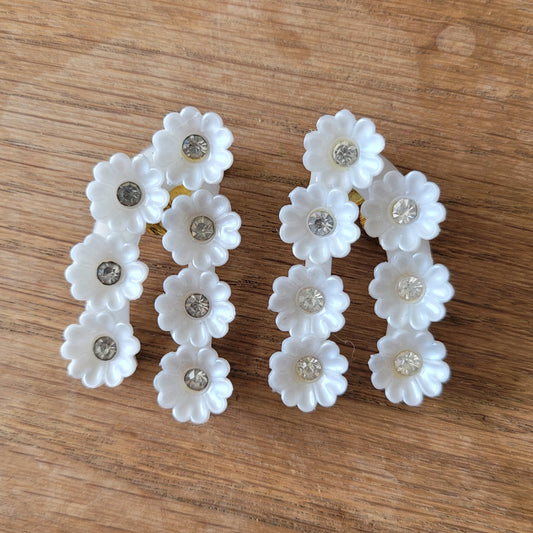 1960s white plastic daisy cluster rhinestone clip-on earrings