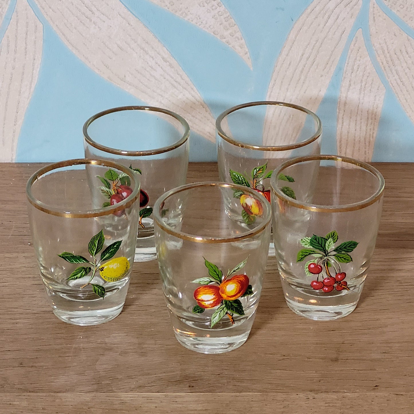 Set of five 1970s fruit patterned shot glasses with gilt trim