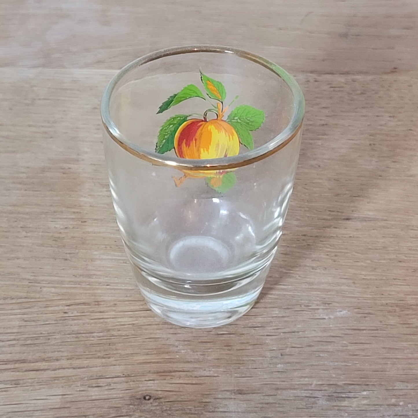 Set of five 1970s fruit patterned shot glasses with gilt trim