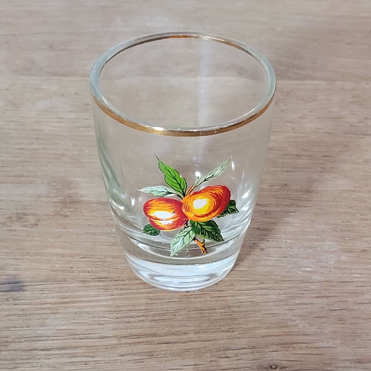 Set of five 1970s fruit patterned shot glasses with gilt trim