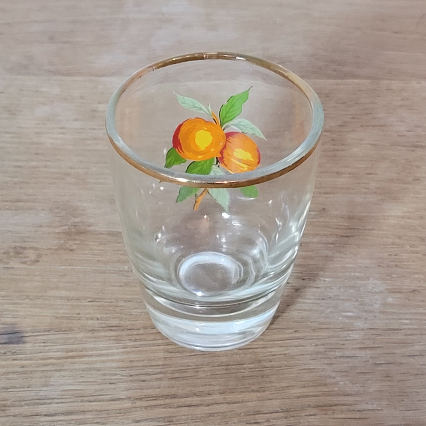 Set of five 1970s fruit patterned shot glasses with gilt trim