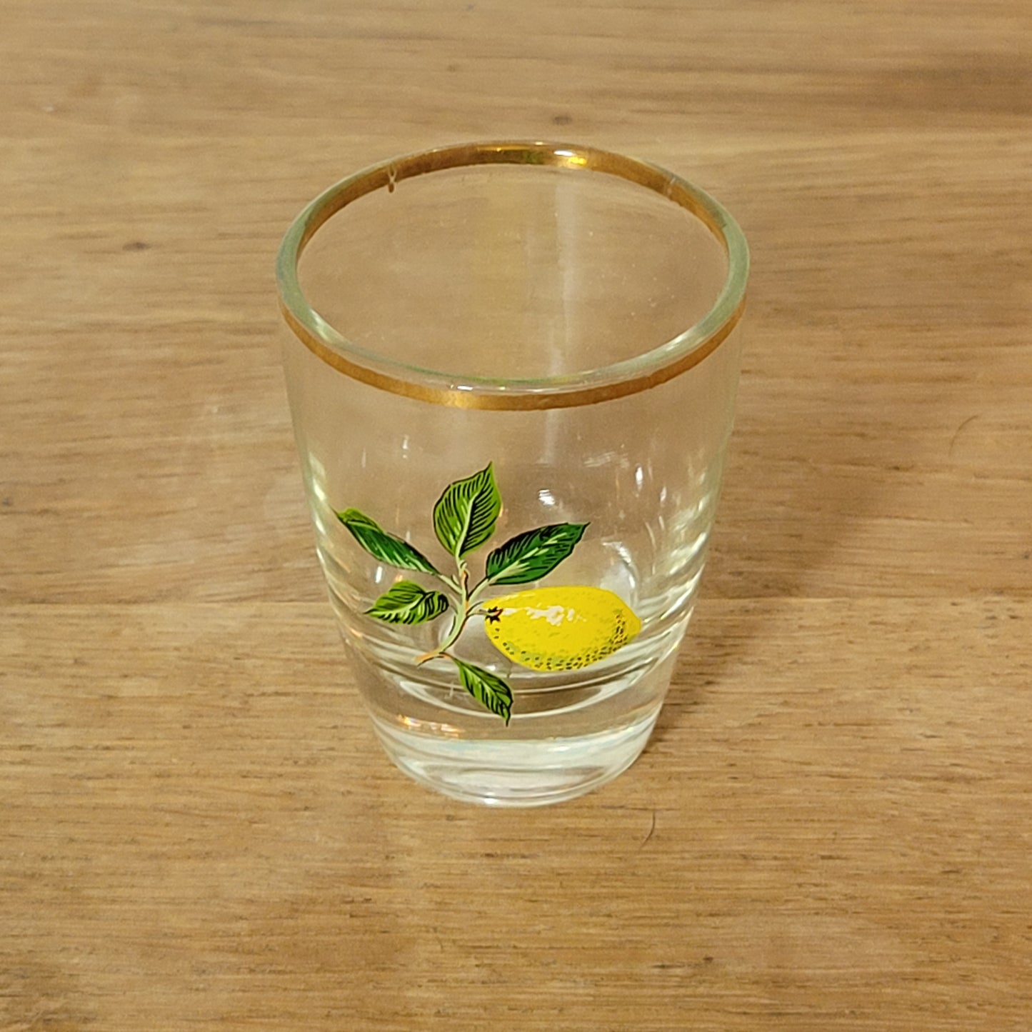 Set of five 1970s fruit patterned shot glasses with gilt trim
