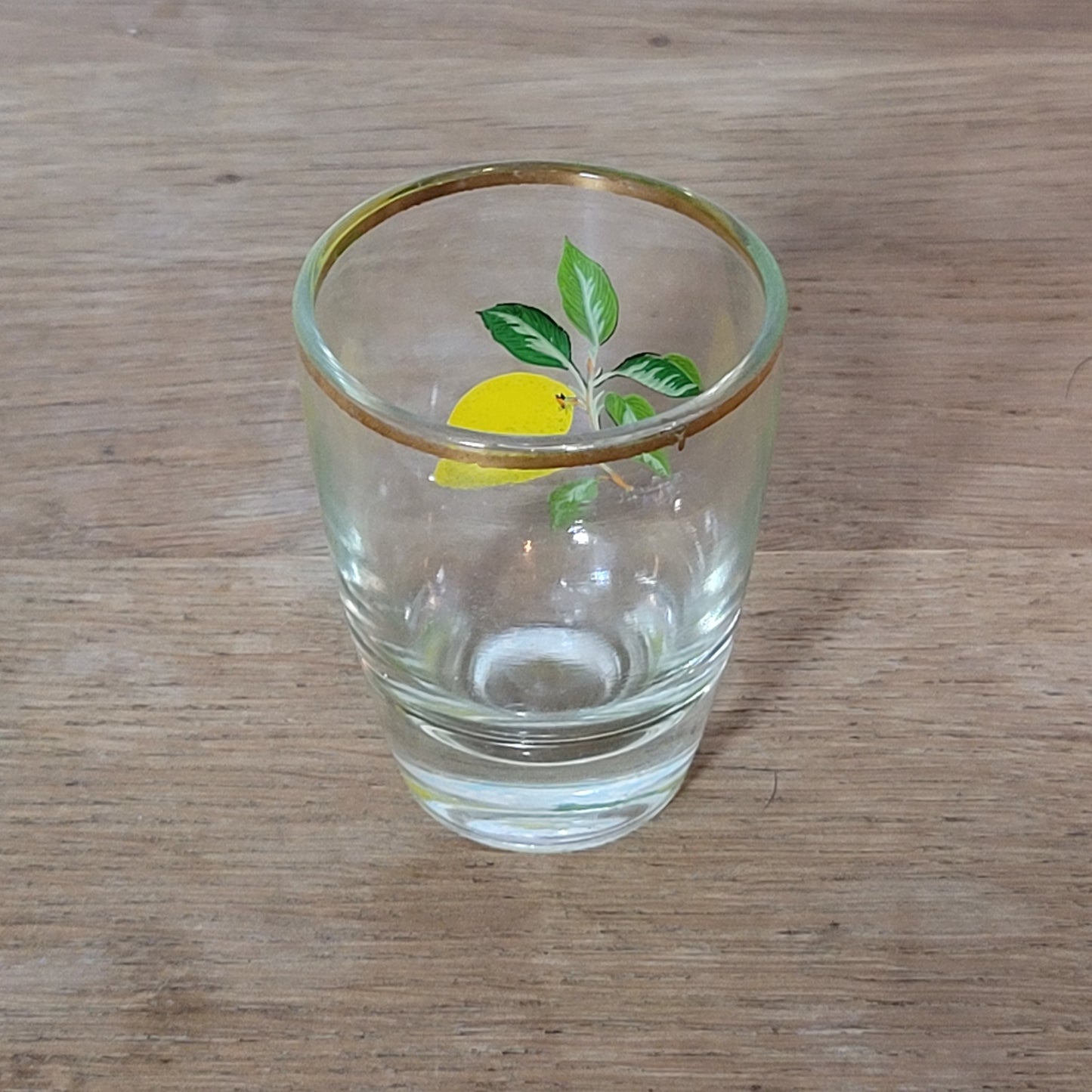 Set of five 1970s fruit patterned shot glasses with gilt trim