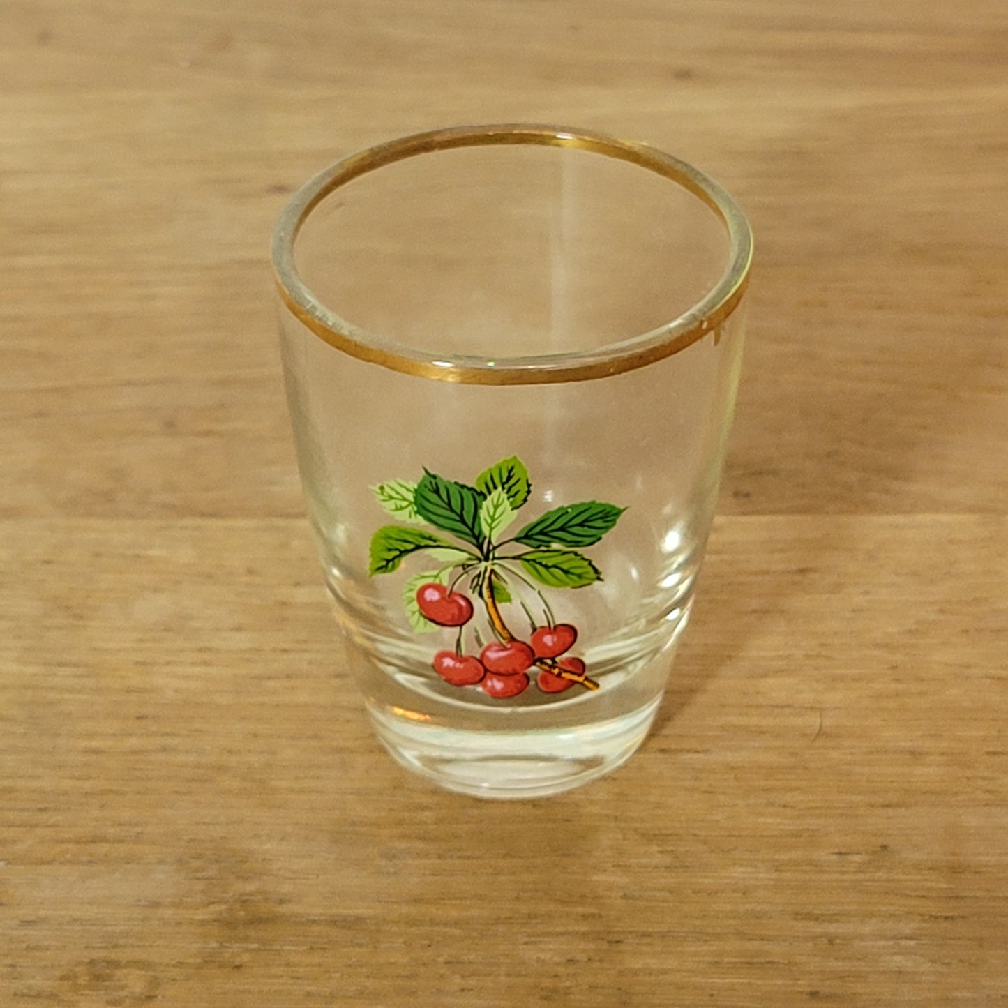 Set of five 1970s fruit patterned shot glasses with gilt trim