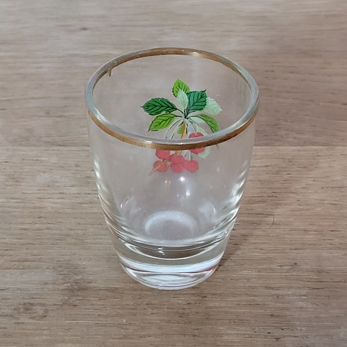 Set of five 1970s fruit patterned shot glasses with gilt trim