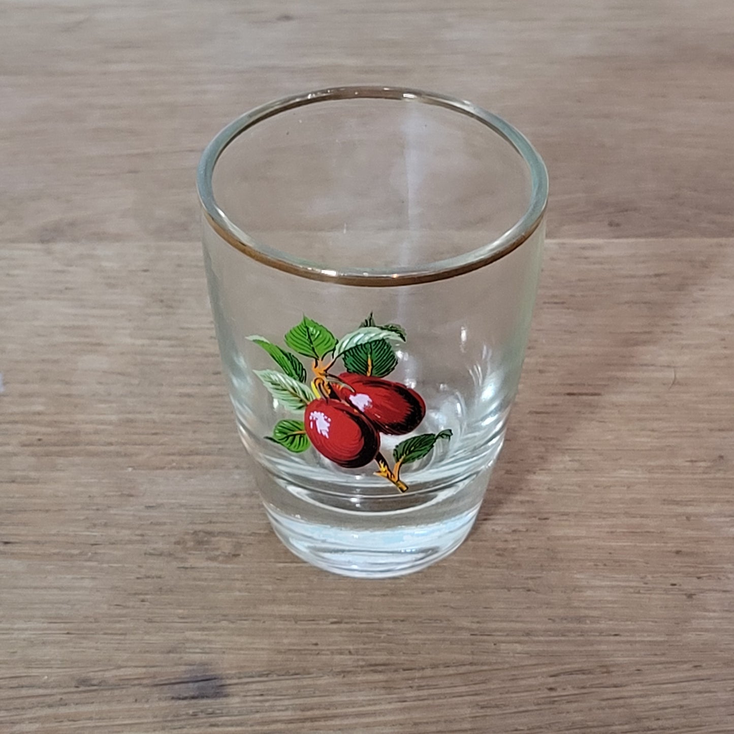 Set of five 1970s fruit patterned shot glasses with gilt trim