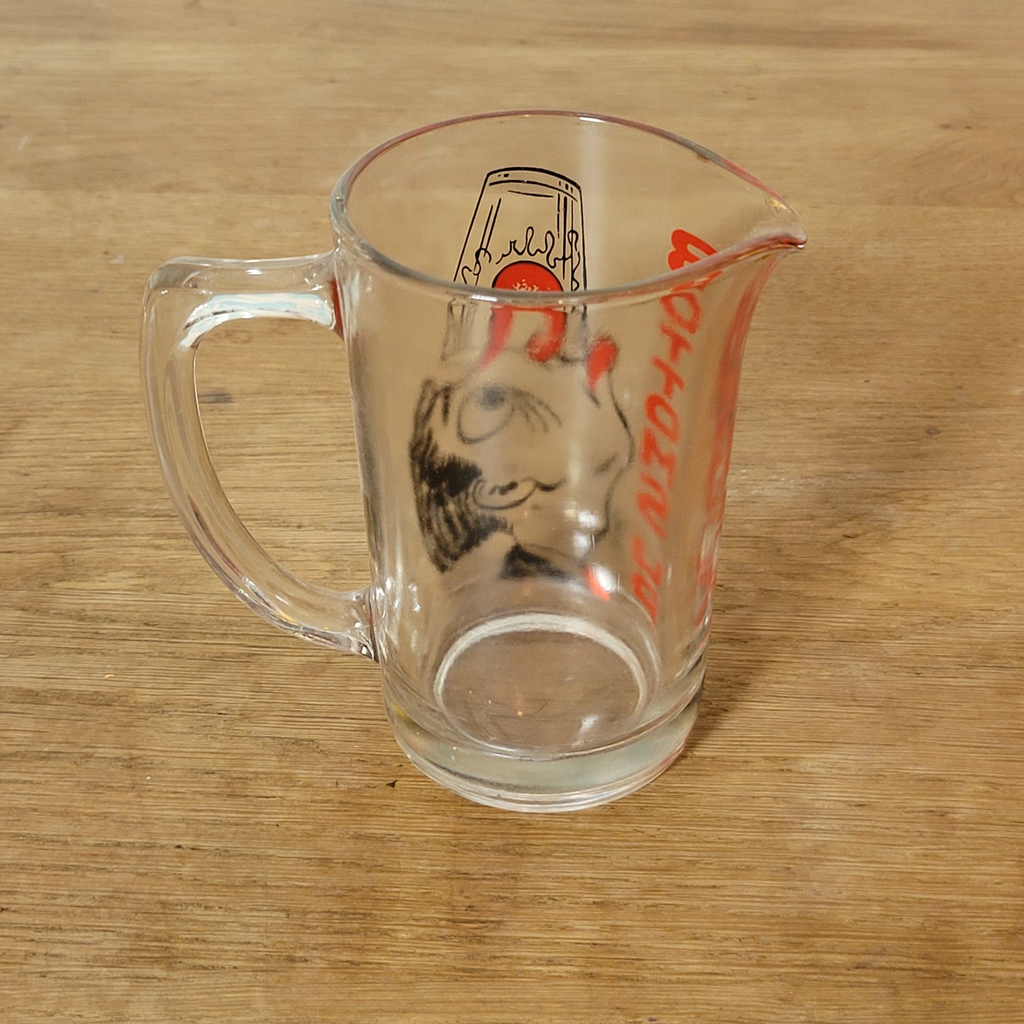Mid-century ‘Bottoms Up’ glass cocktail mixer jug with drunken man design