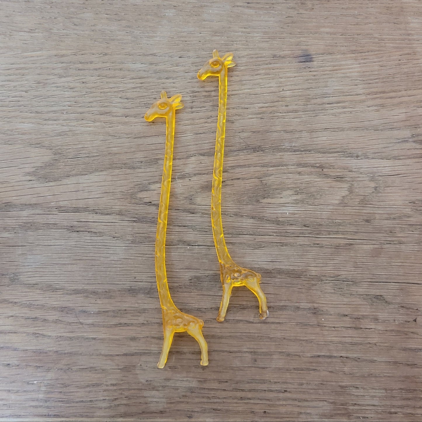 Pair of 1960s orange plastic giraffe swizzle sticks