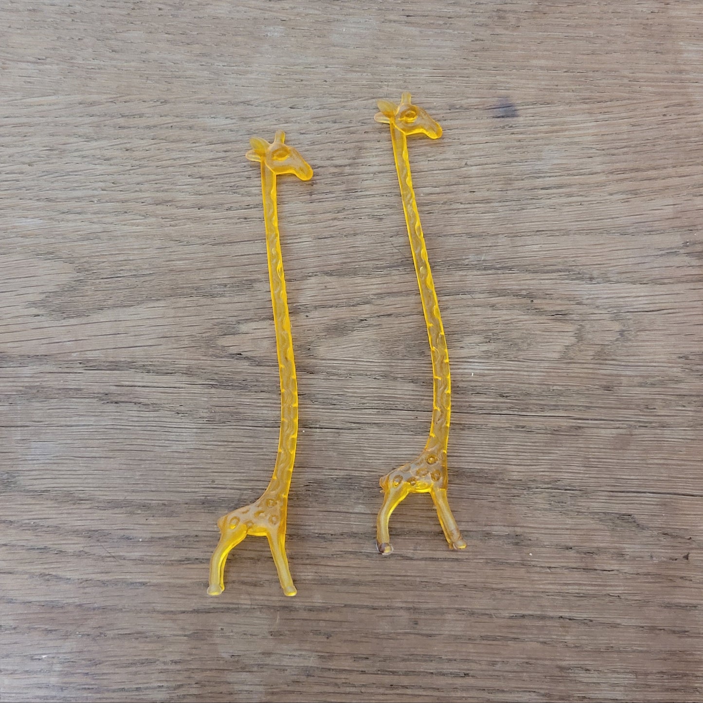 Pair of 1960s orange plastic giraffe swizzle sticks