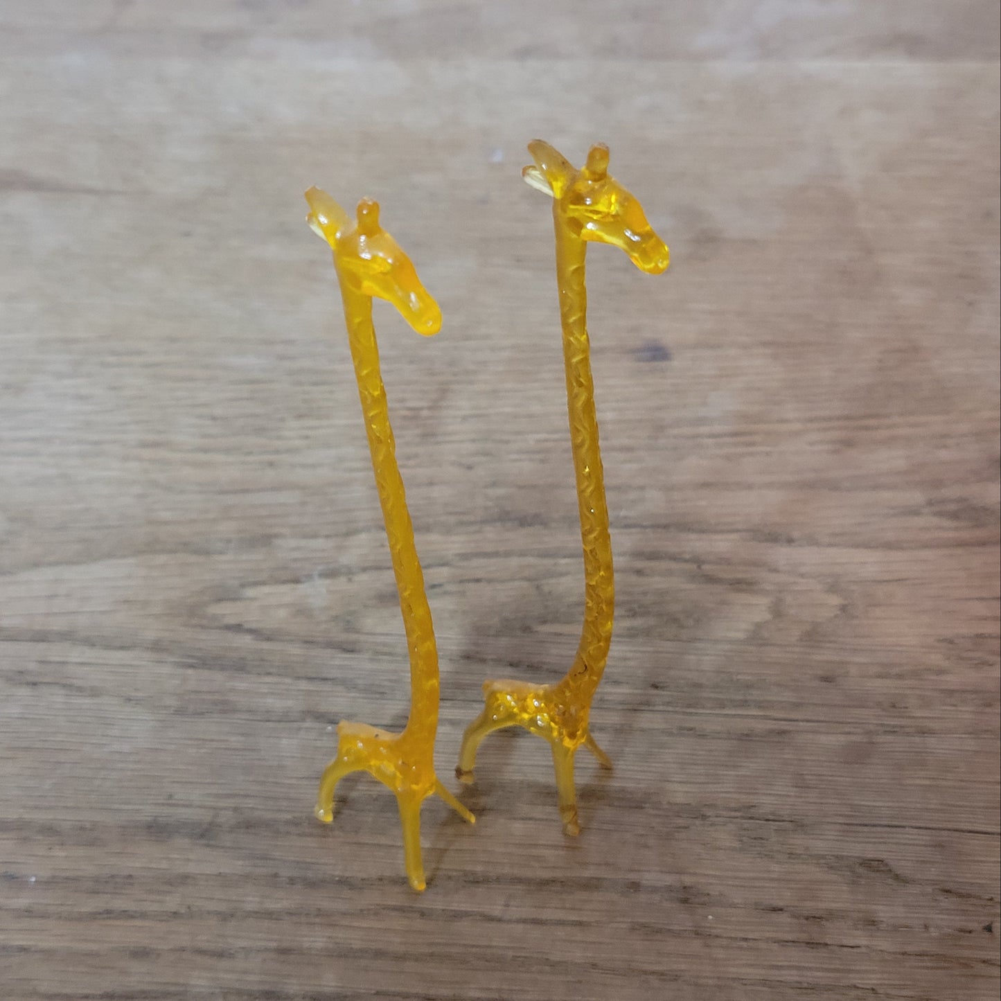 Pair of 1960s orange plastic giraffe swizzle sticks