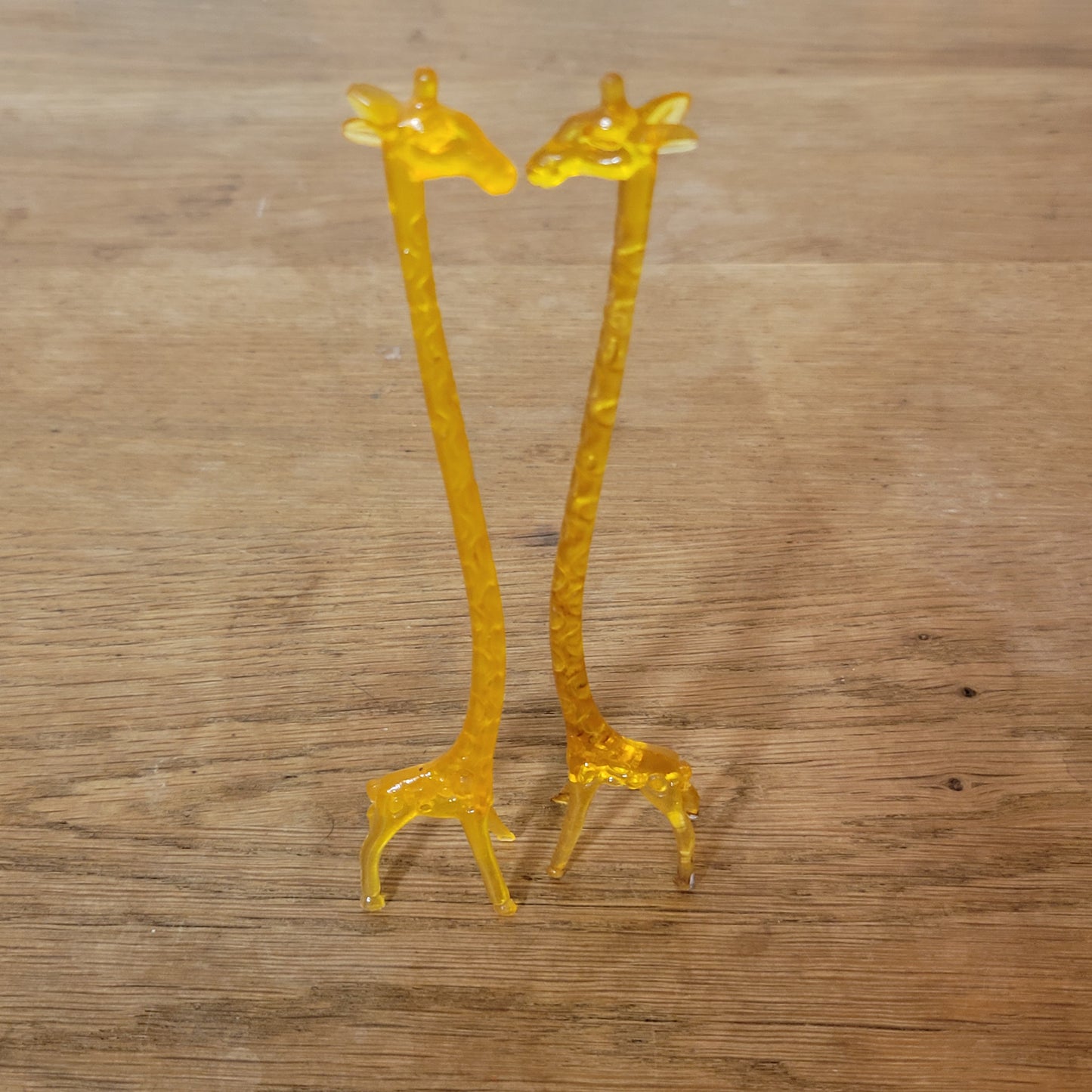 Pair of 1960s orange plastic giraffe swizzle sticks