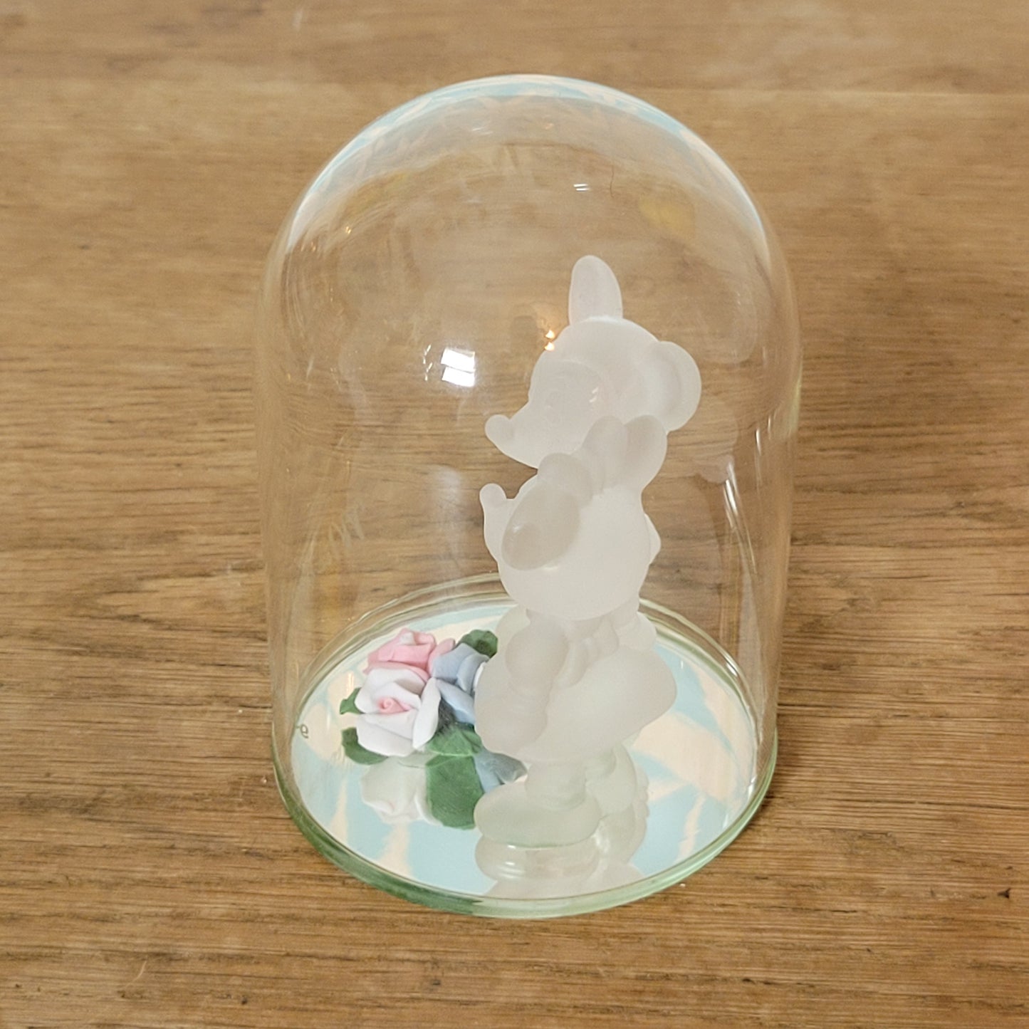 Collectable Disney frosted glass Minnie & Mickey Mouse figurines displayed under glass cloche
