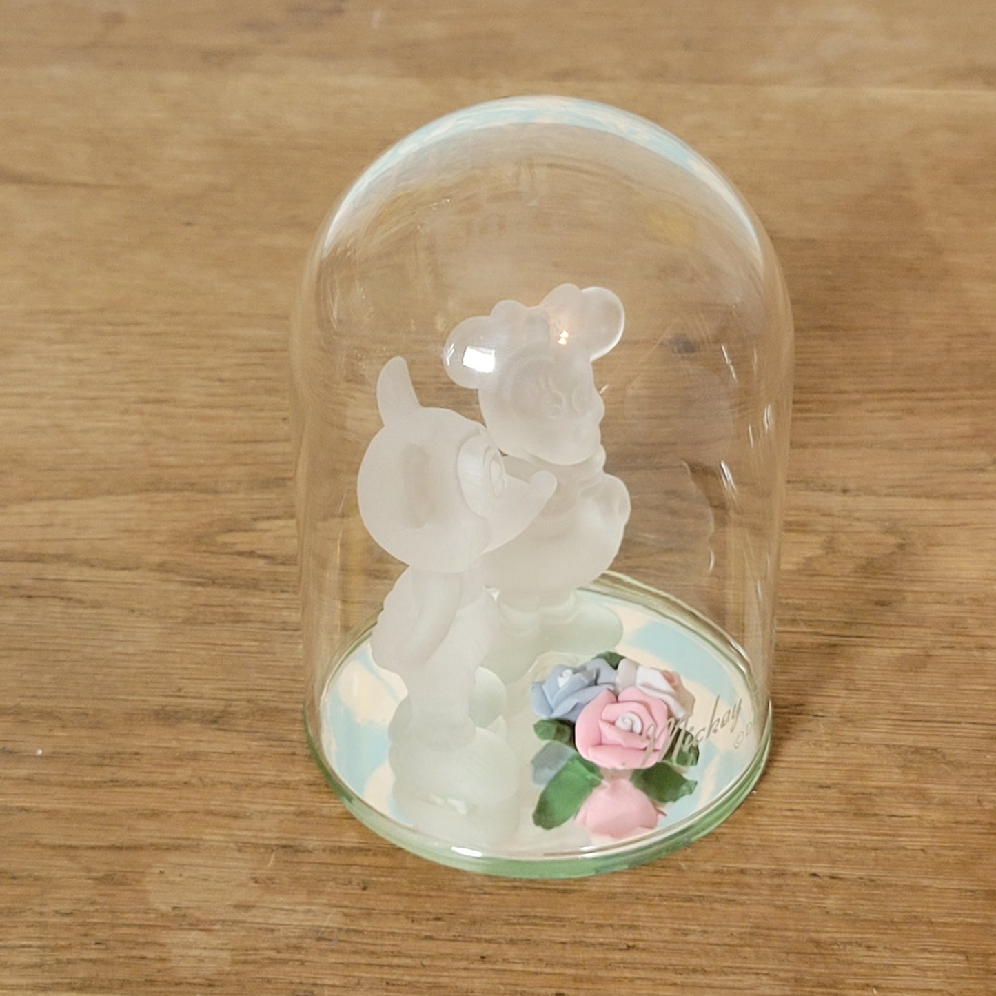 Collectable Disney frosted glass Minnie & Mickey Mouse figurines displayed under glass cloche
