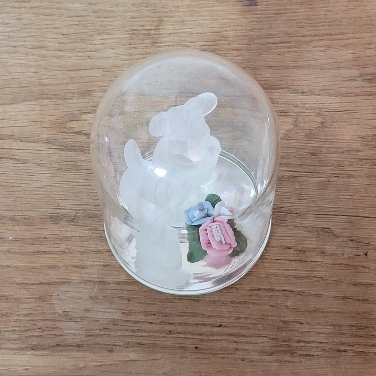 Collectable Disney frosted glass Minnie & Mickey Mouse figurines displayed under glass cloche