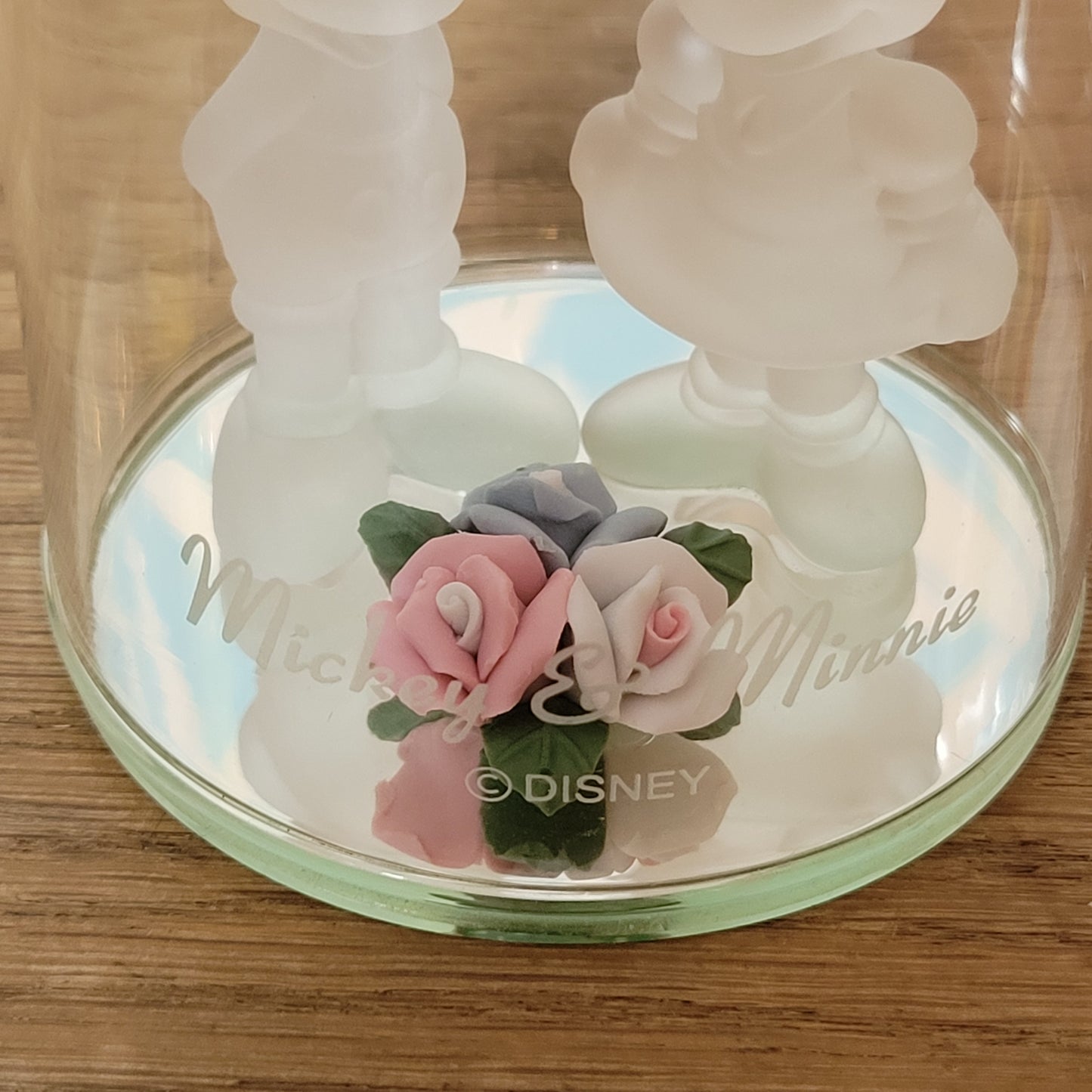 Collectable Disney frosted glass Minnie & Mickey Mouse figurines displayed under glass cloche