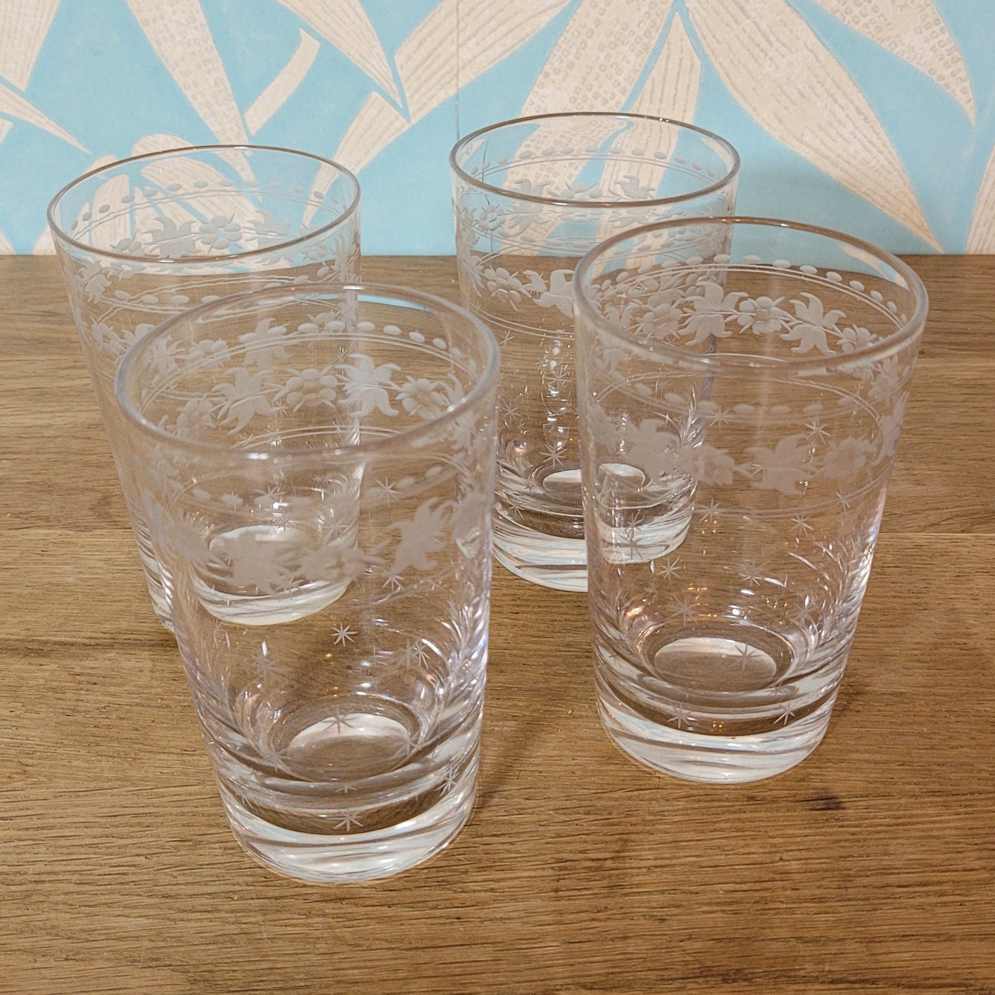 Set of 1950s cut glass tumblers and matching sherry glasses with floral and starburst design