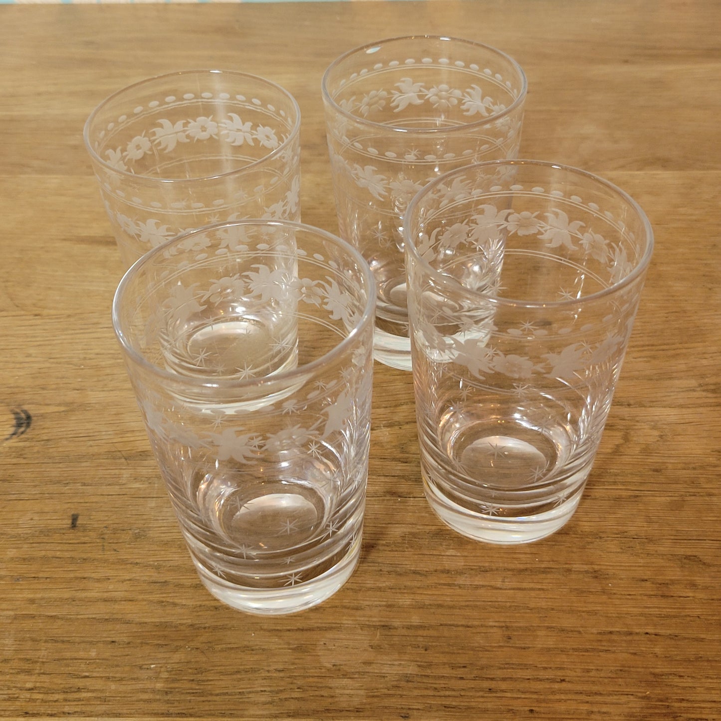 Set of 1950s cut glass tumblers and matching sherry glasses with floral and starburst design