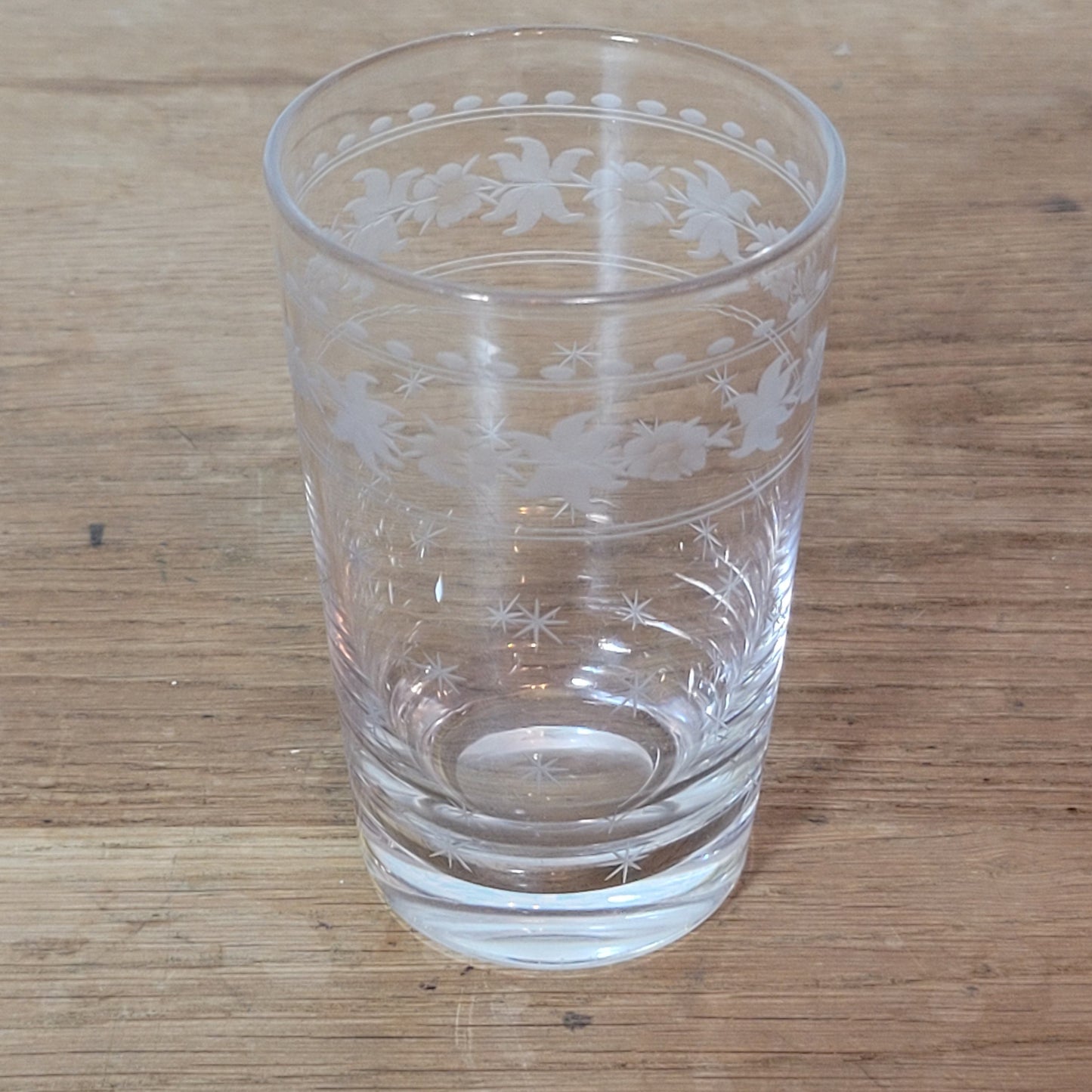 Set of 1950s cut glass tumblers and matching sherry glasses with floral and starburst design