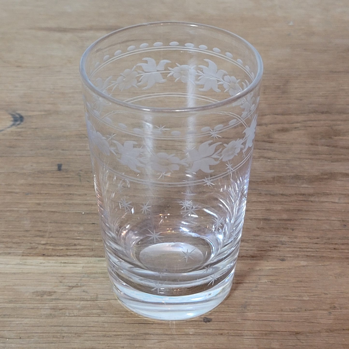 Set of 1950s cut glass tumblers and matching sherry glasses with floral and starburst design
