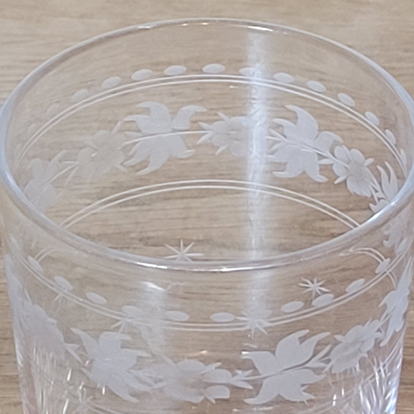 Set of 1950s cut glass tumblers and matching sherry glasses with floral and starburst design