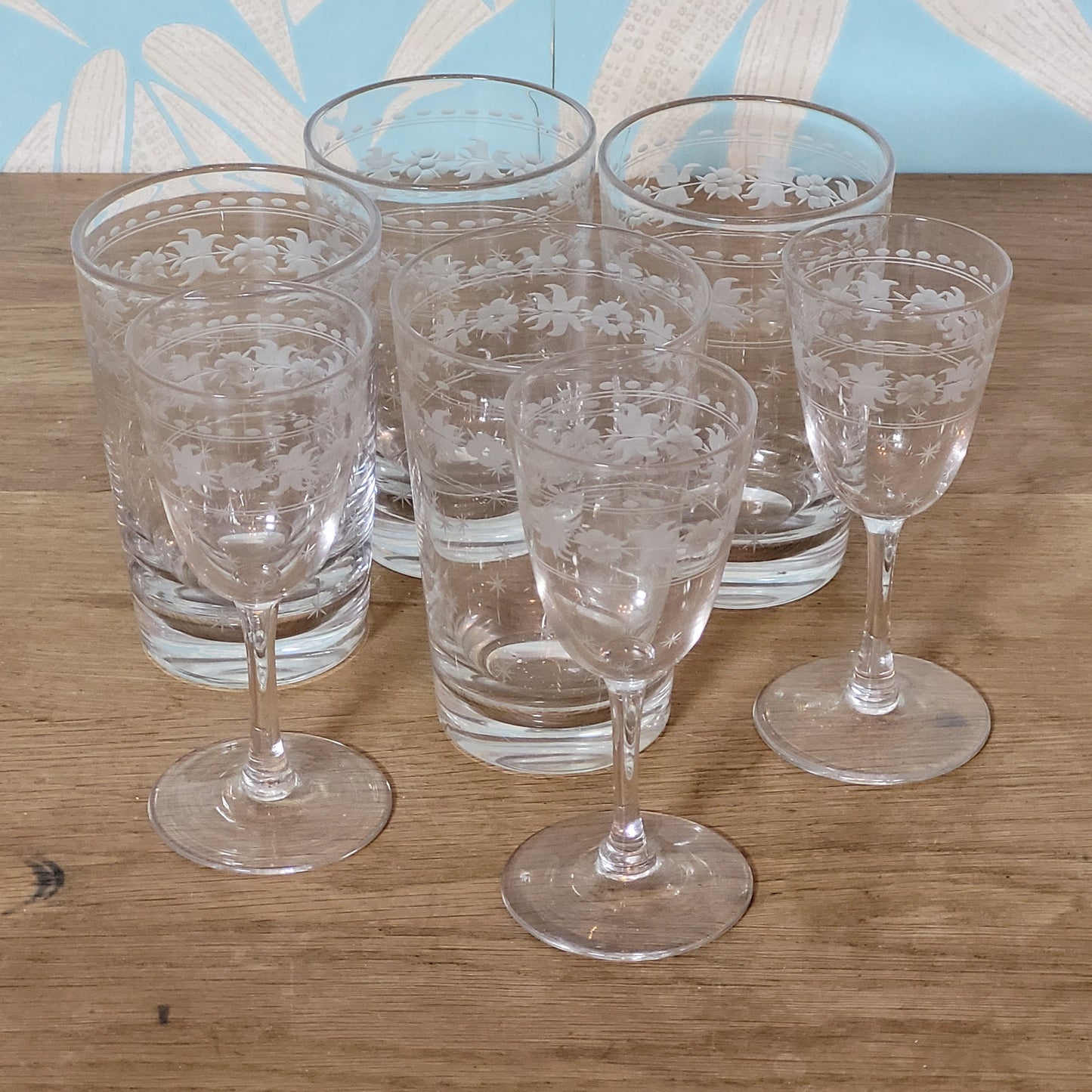 Set of 1950s cut glass tumblers and matching sherry glasses with floral and starburst design