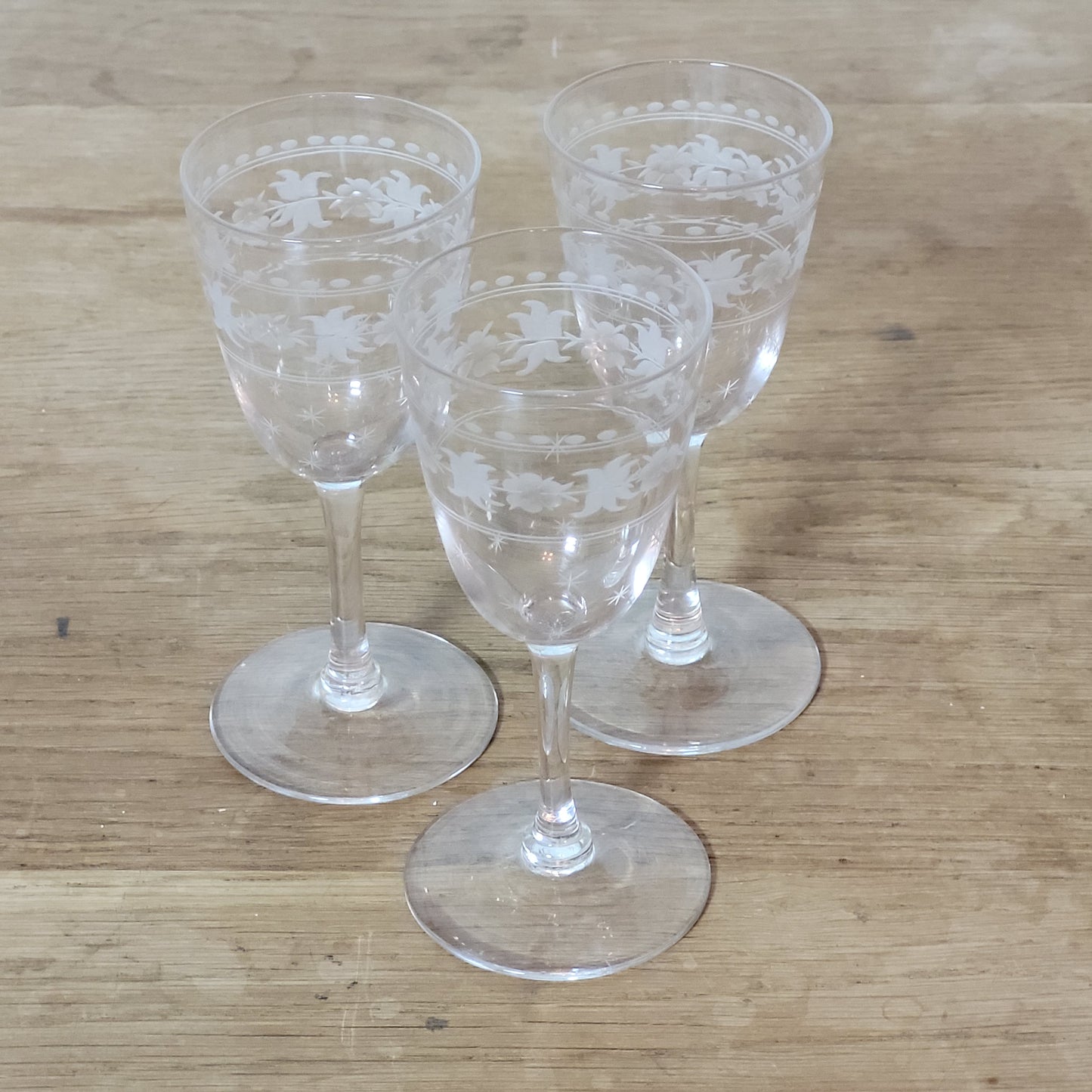 Set of 1950s cut glass tumblers and matching sherry glasses with floral and starburst design