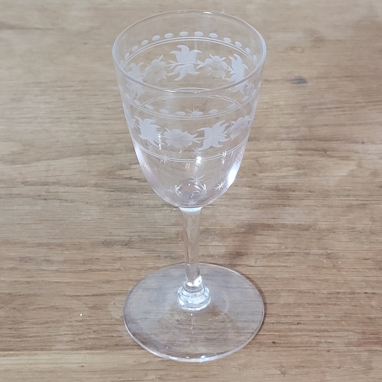 Set of 1950s cut glass tumblers and matching sherry glasses with floral and starburst design