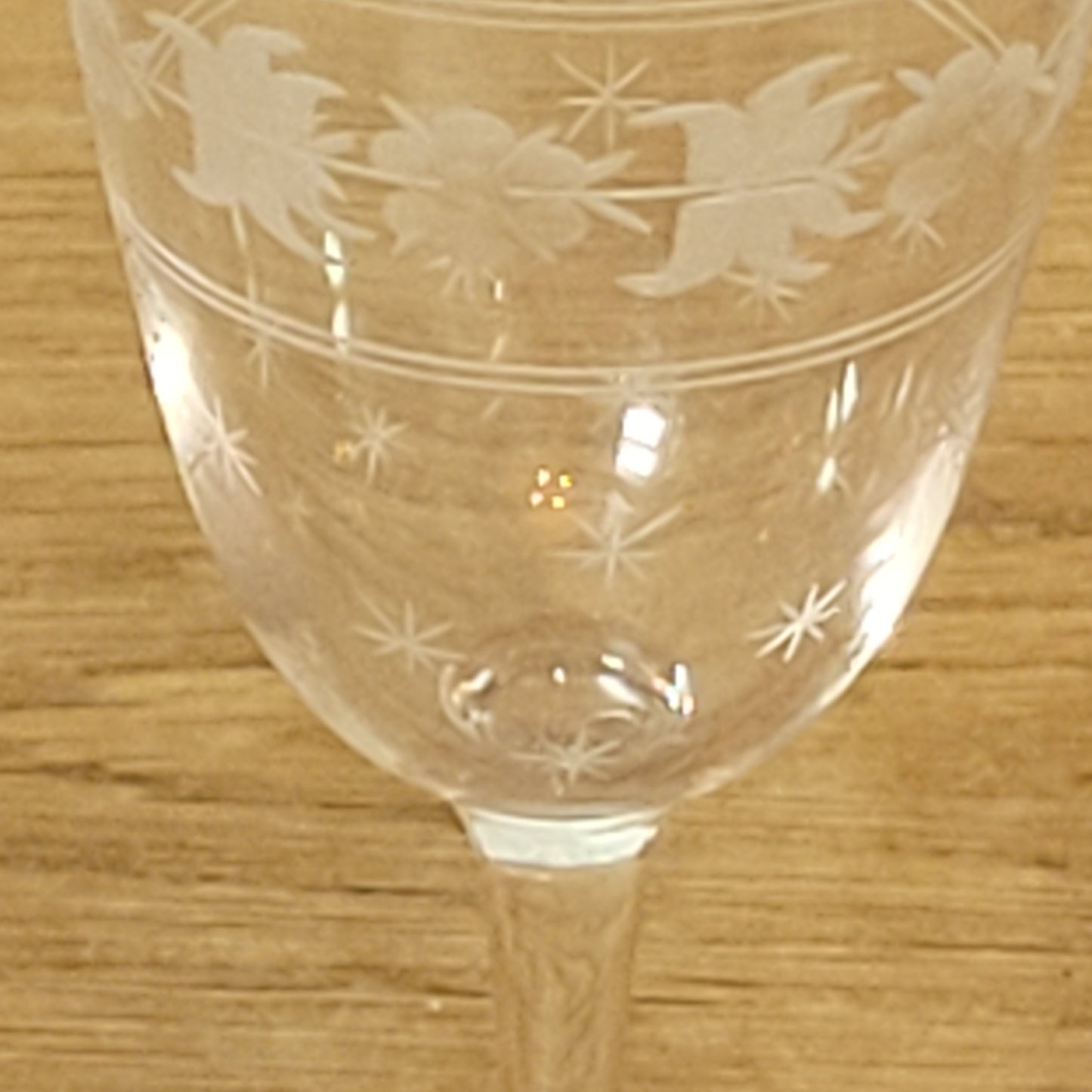 Set of 1950s cut glass tumblers and matching sherry glasses with floral and starburst design